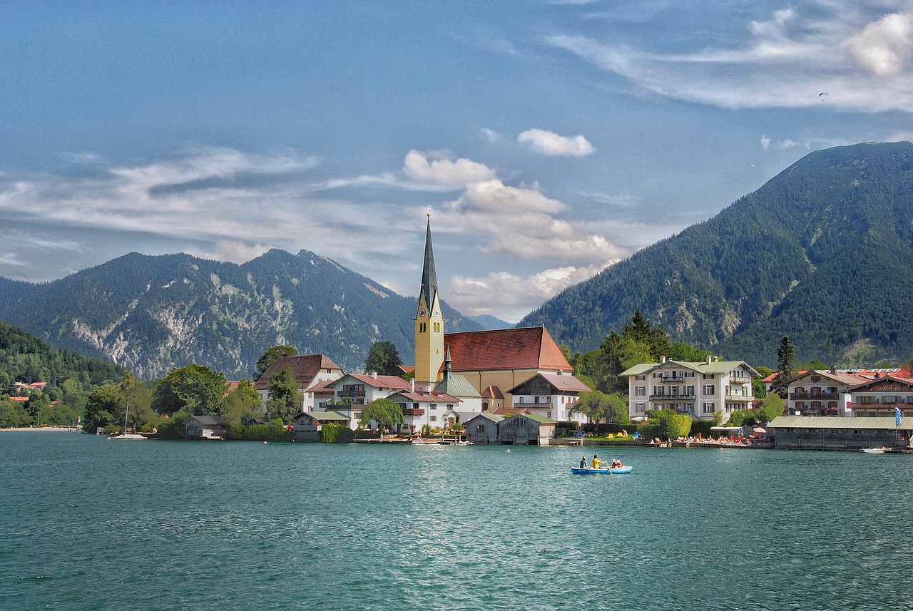 View of the Tegernsee with mountains in the background and a church