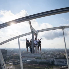 Sky Thrill platform Umadum. People stand on the Ferris wheel secured with a rope, only on a grid at a height of 80 meters. No protective walls on the side