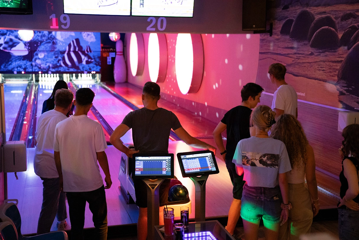 A group of people playing bowling together