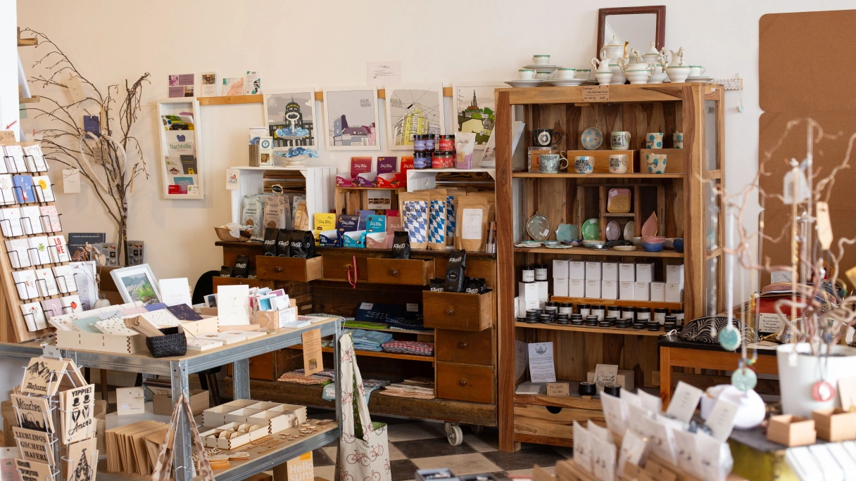 A souvenir and gift store in Munich. Many shelves with various little things, such as postcards, soap, drinks, sweets and much more