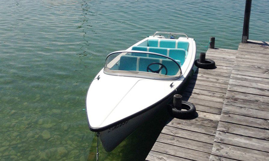 Electric boat on jetty in water