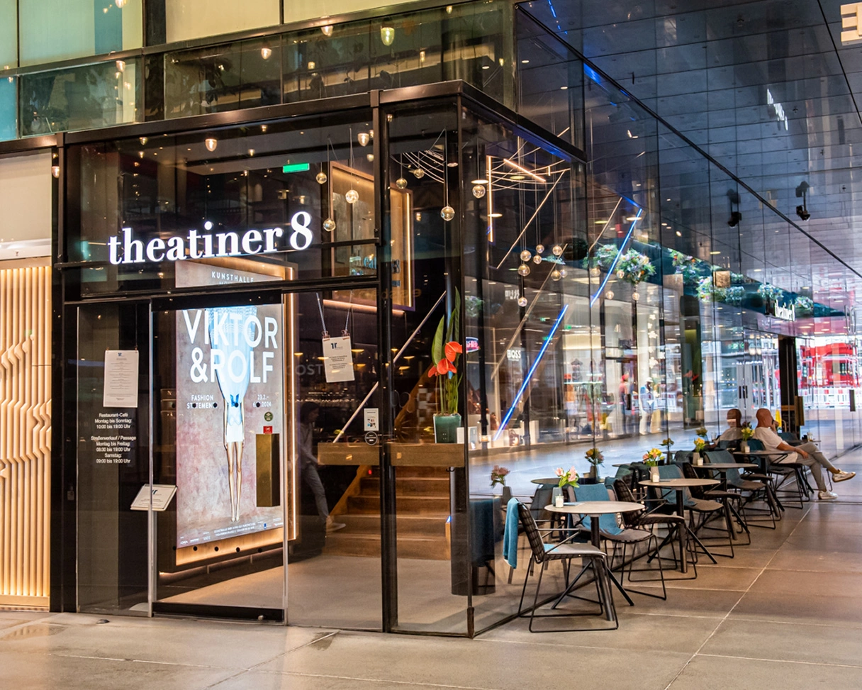 Entrance area of Café Theatiner 8, with outdoor seating to the side