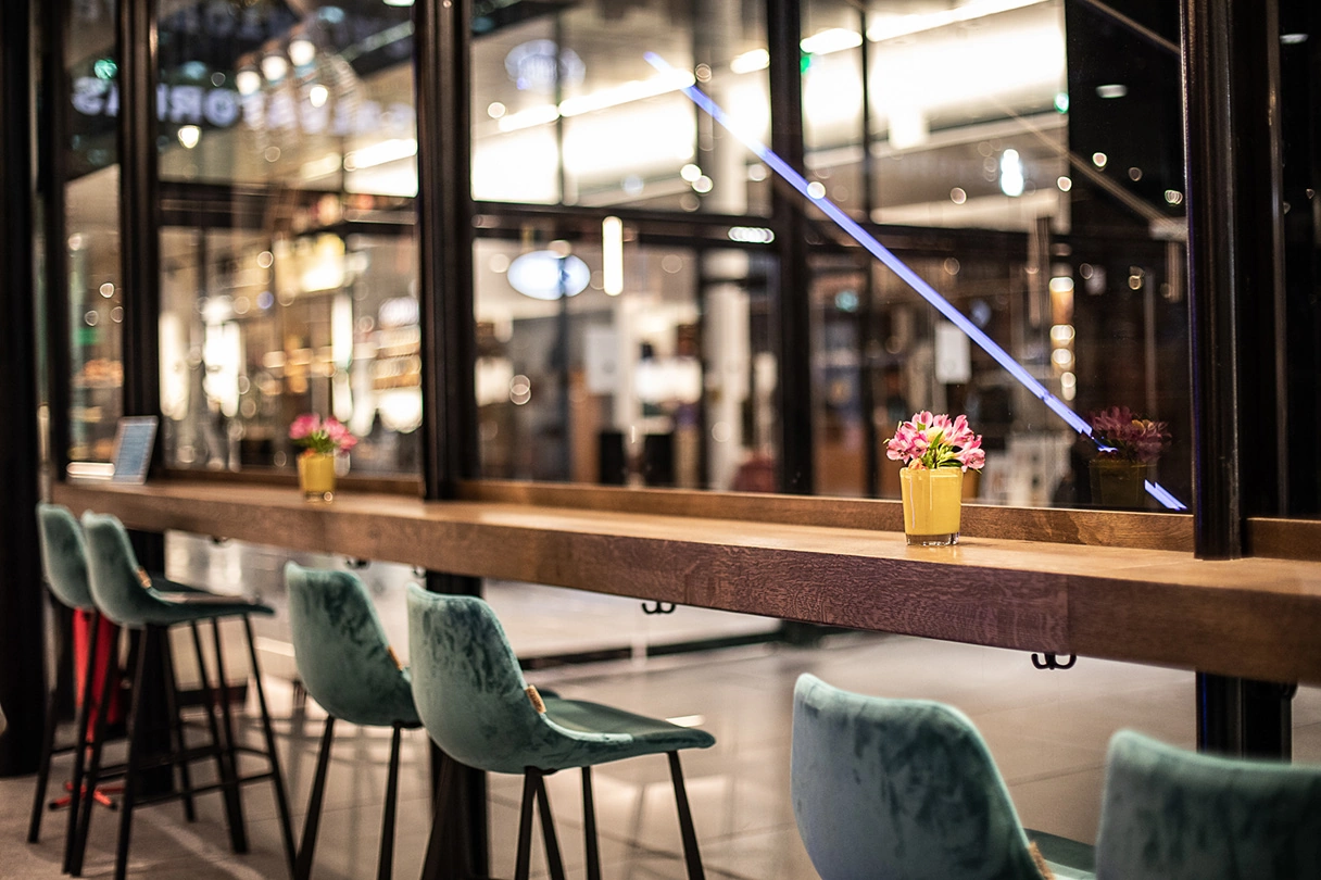 Seating in the Theatiner 8 Café. Table counter by the window and high bar stools