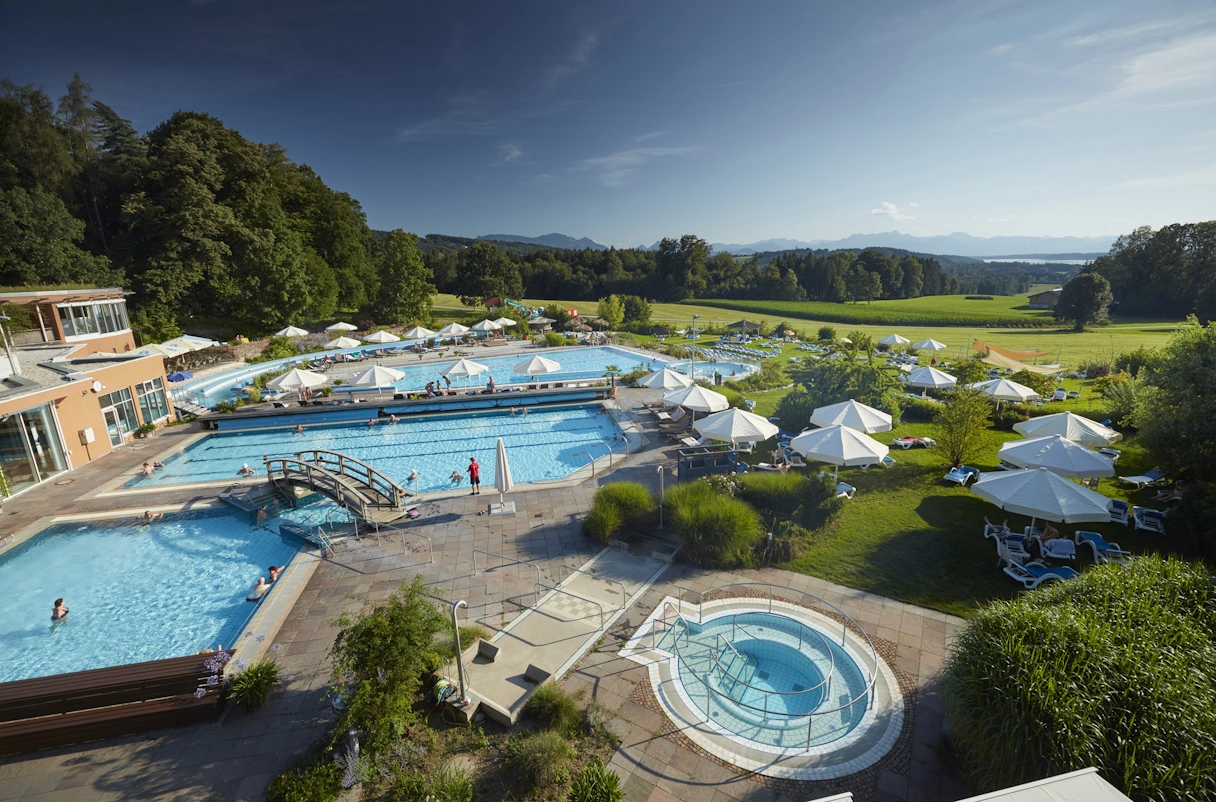 Chiemgau Thermen outdoor area with pool, surrounded by green nature