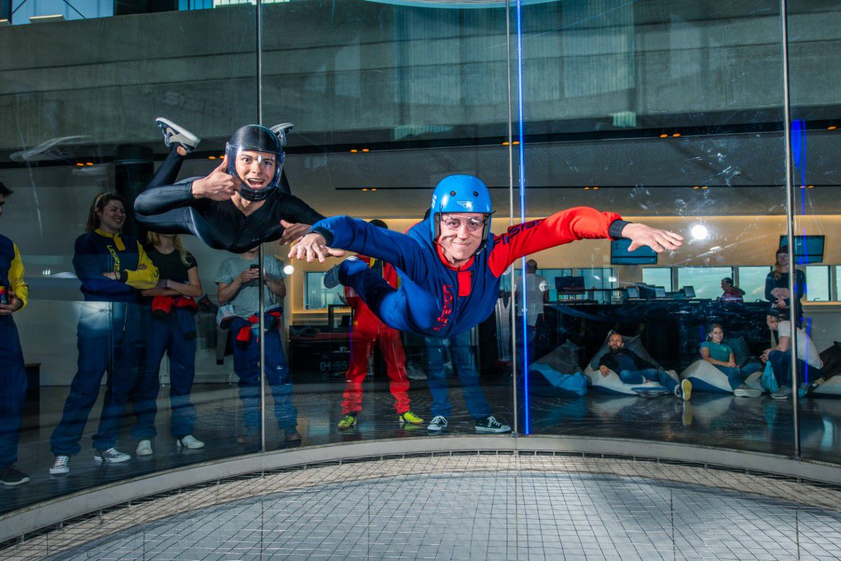 Man floating in wind tunnel with stretched arms and legs