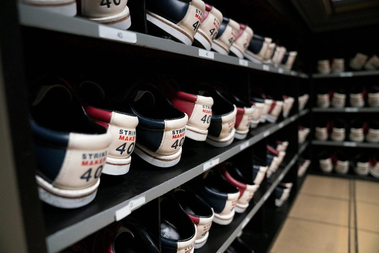 Bowling shoes lined up on a shelf