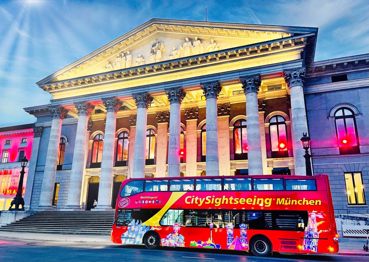 Red sightseeing bus in Munich in front of opera house