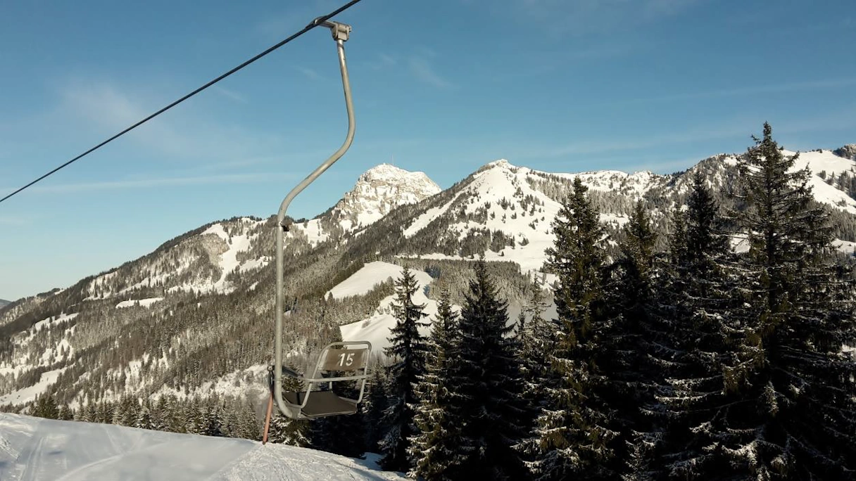 Ski lift in Sudelfeld. Snow-covered mountains in the background