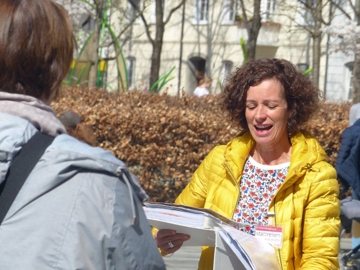 Tour guide Kristin reads from a book to the group